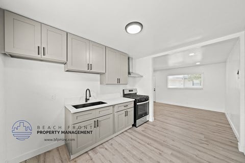 a white kitchen with white cabinets and a white counter top